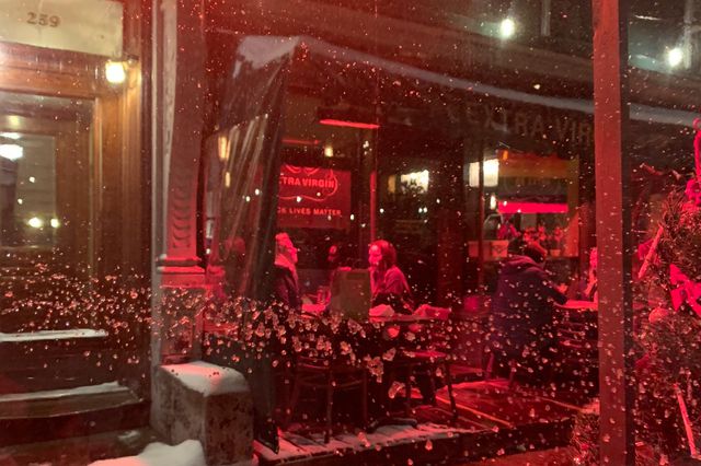 A photo of people dining at Extra Virgin during the snowstorm on Dec 16, 2020